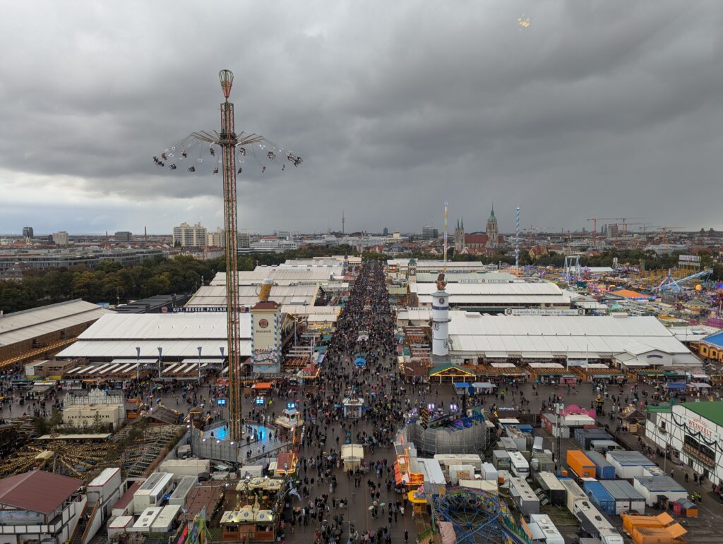 Aerial view of the Oktoberfest Theresienwiese grounds showing all the beer tents, rides and crowds from above