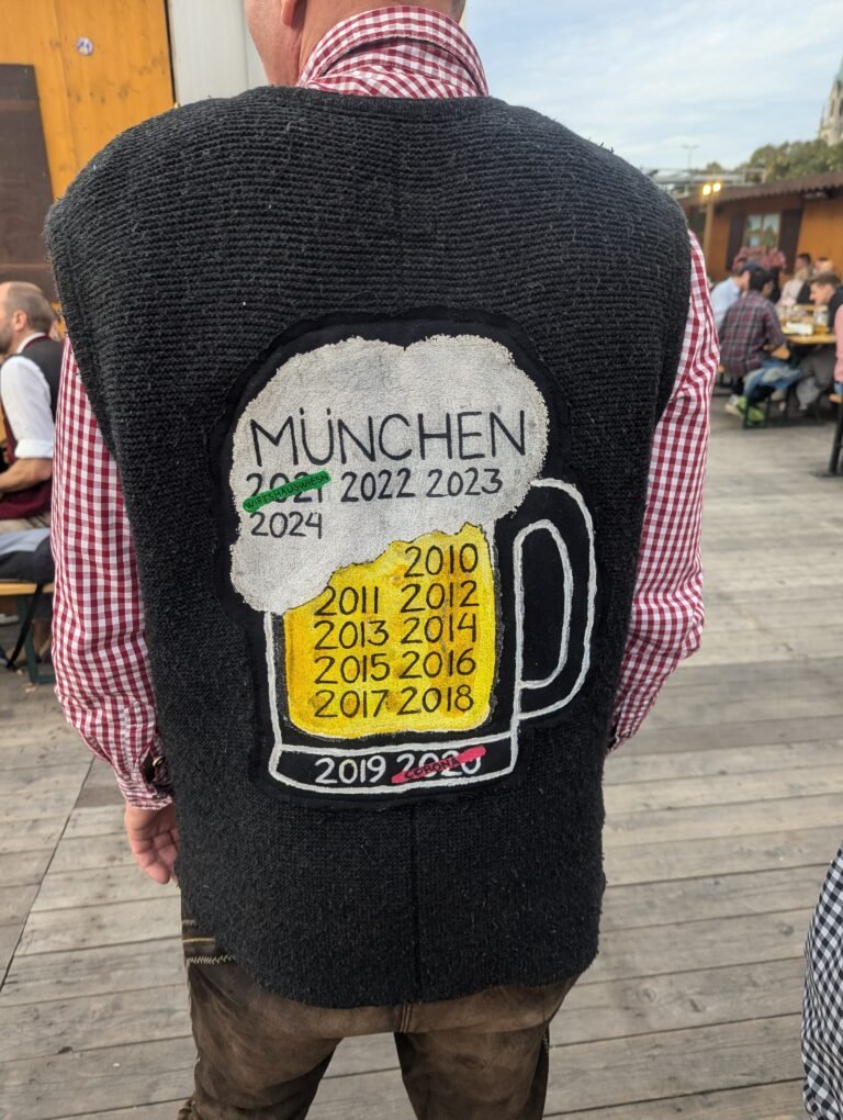 Man wearing a traditional Bavarian Tracht waistcoat and checked shirt at Oktoberfest