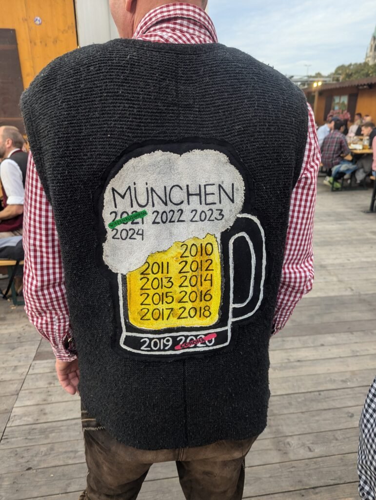 Man wearing a traditional Bavarian Tracht waistcoat and checked shirt at Oktoberfest