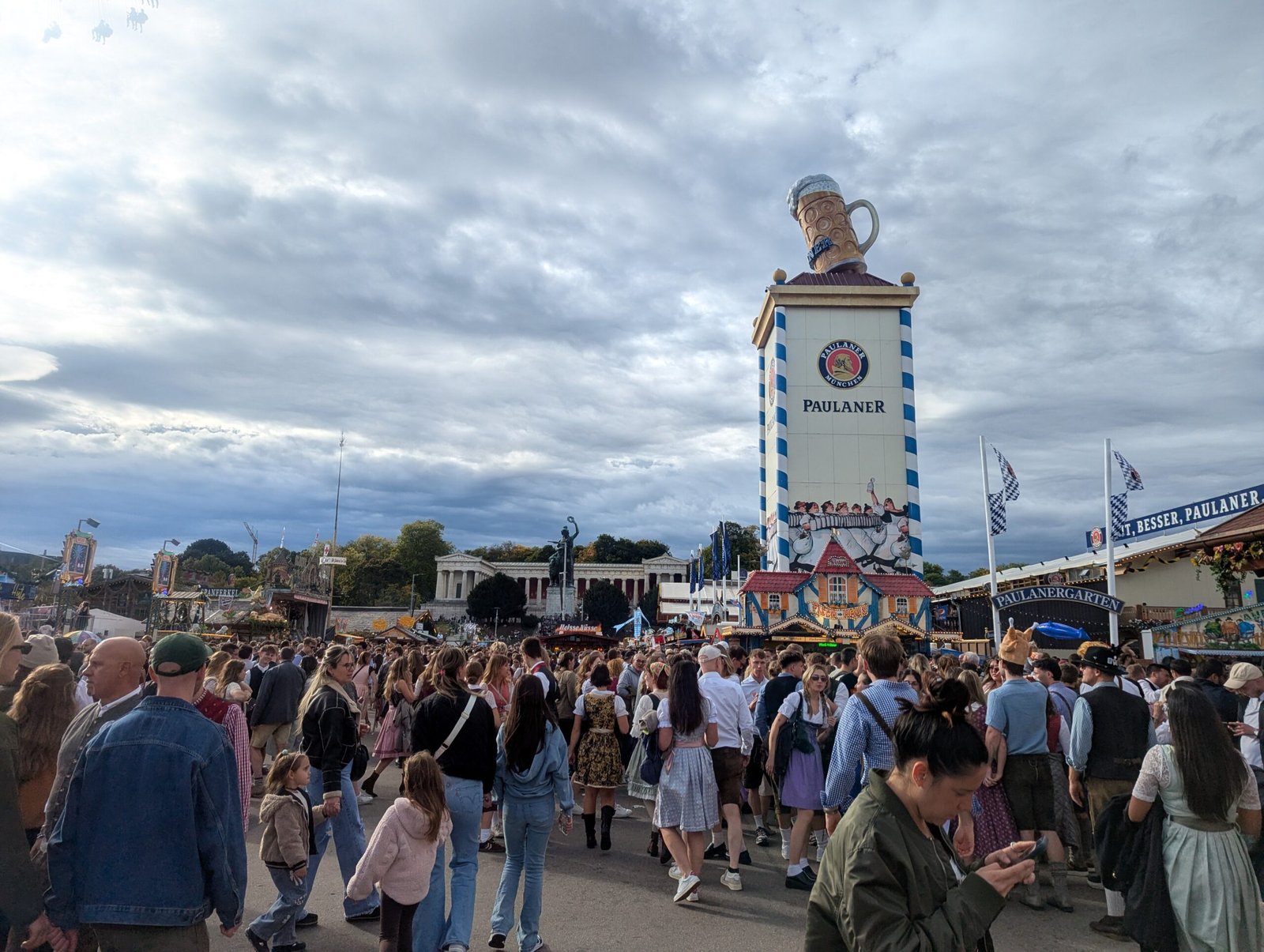 Crowds in dirndls and lederhosen by the Paulaner tower at Oktoberfest
