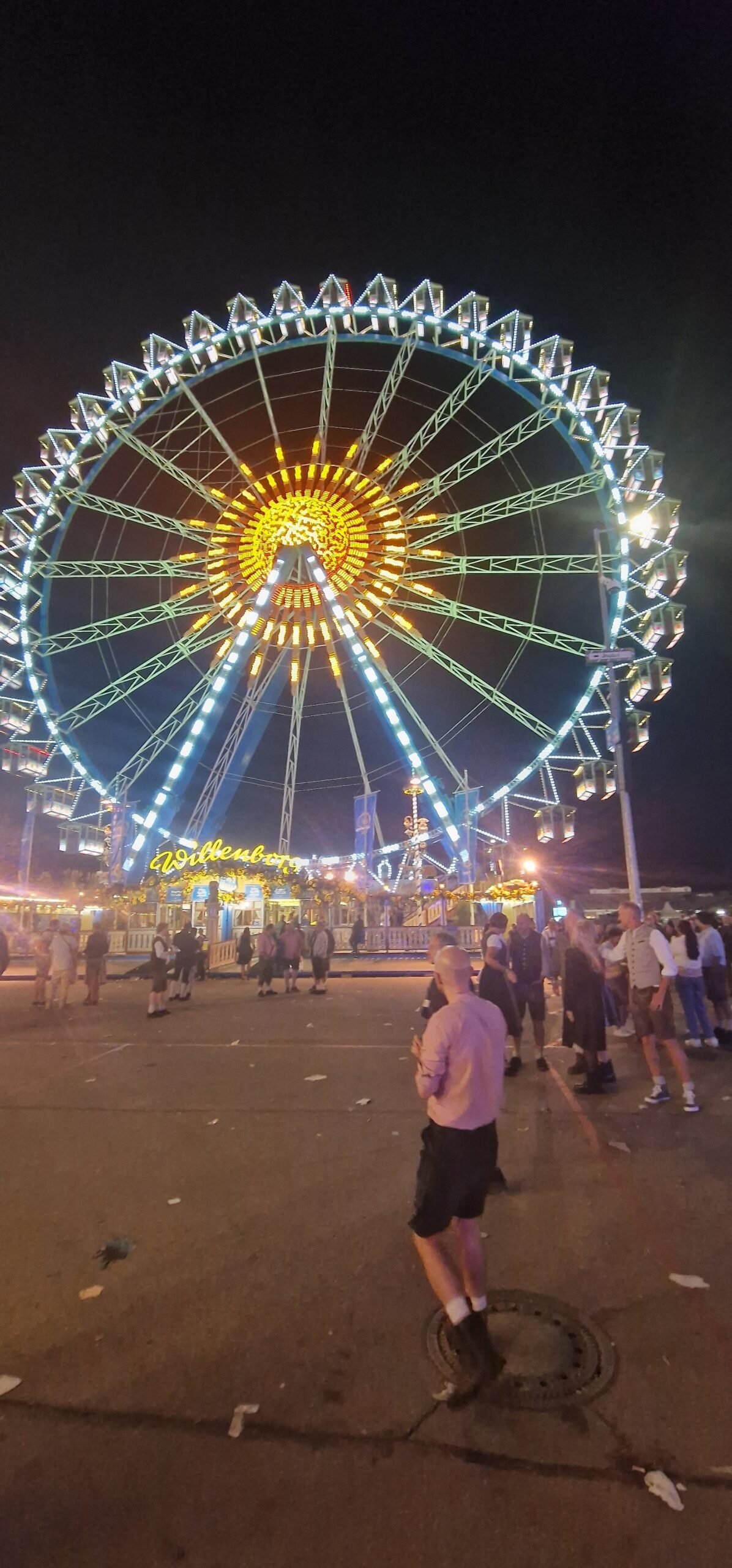 The Oktoberfest Ferris wheel lit up at night in Munich